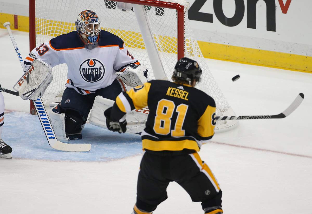 Pittsburgh Penguins’ Phil Kessel (81) tries to swat the puck out of the air in front of Edmonton Oilers goalie Cam Talbot (33) in the first period of an NHL hockey game in Pittsburgh, Tuesday, Oct. 24, 2017. (AP Photo/Gene J. Puskar)