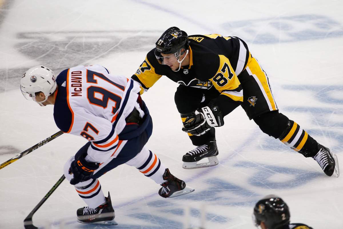 Pittsburgh Penguins’ Sidney Crosby (87) tries to slow down Edmonton Oilers’ Connor McDavid (97) in the third period of an NHL hockey game in Pittsburgh, Tuesday, Oct. 24, 2017. The Penguins won 2-1 in overtime. (AP Photo/Gene J. Puskar)