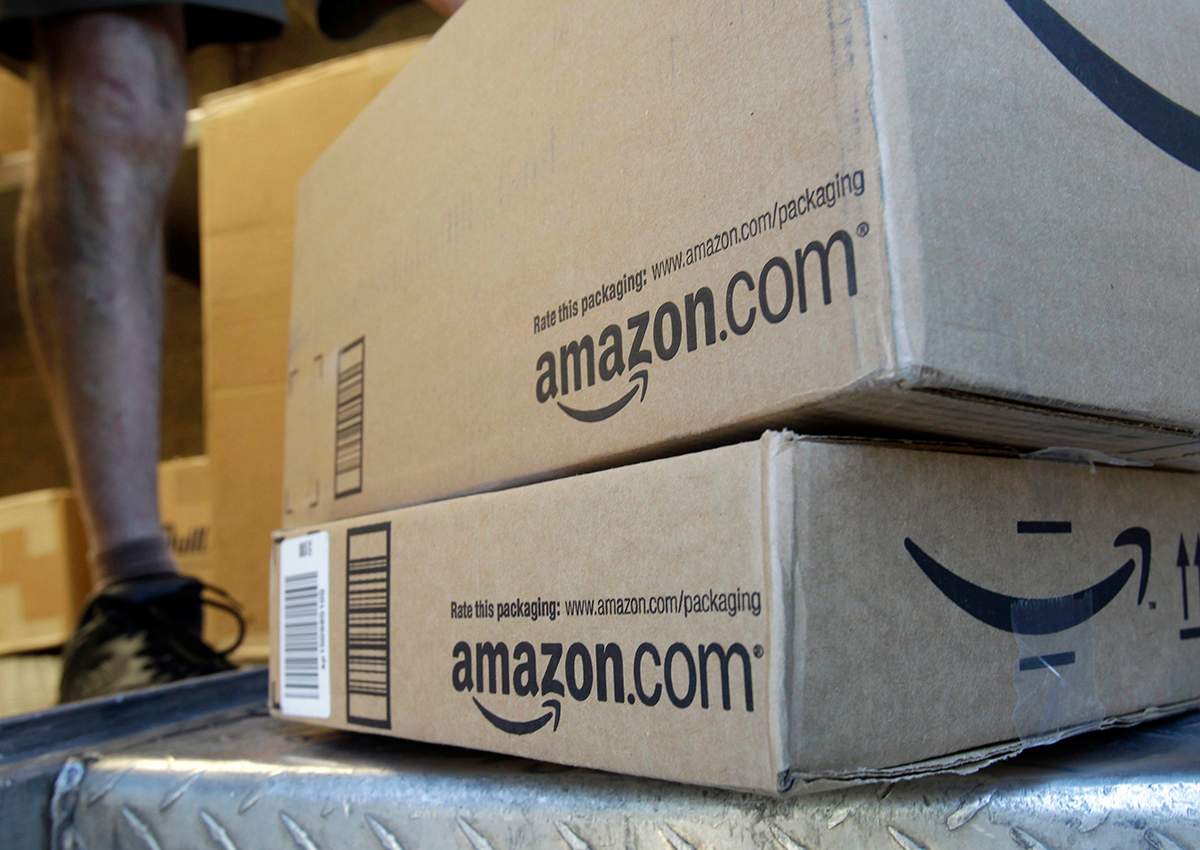 In this June 30, 2011, file photo, a United Parcel Service driver delivers packages from Amazon.com in Palo Alto, Calif. 