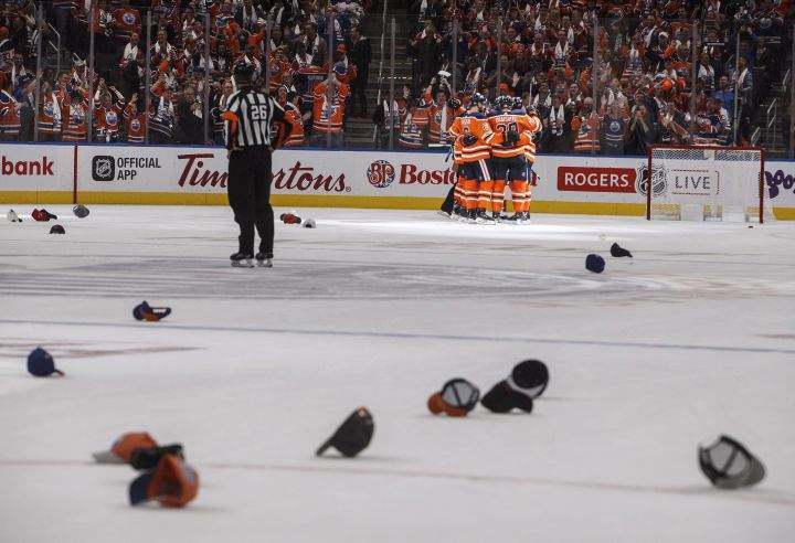 Edmonton Oilers' Connor McDavid (97) celebrates his hat trick with teammates against the Calgary Flames during third period NHL action in Edmonton, Alta., on Wednesday October 4, 2017. 