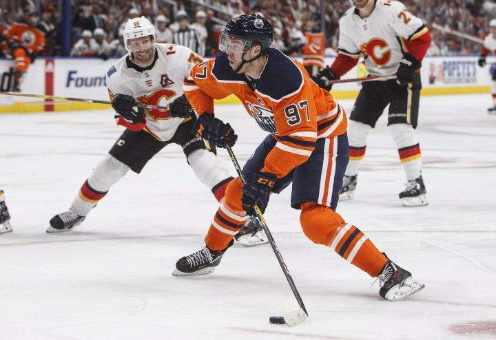 Calgary Flames’ Troy Brouwer (36) chases Edmonton Oilers’ Connor McDavid (97) during second period NHL action in Edmonton, Alta., on Wednesday October 4, 2017.