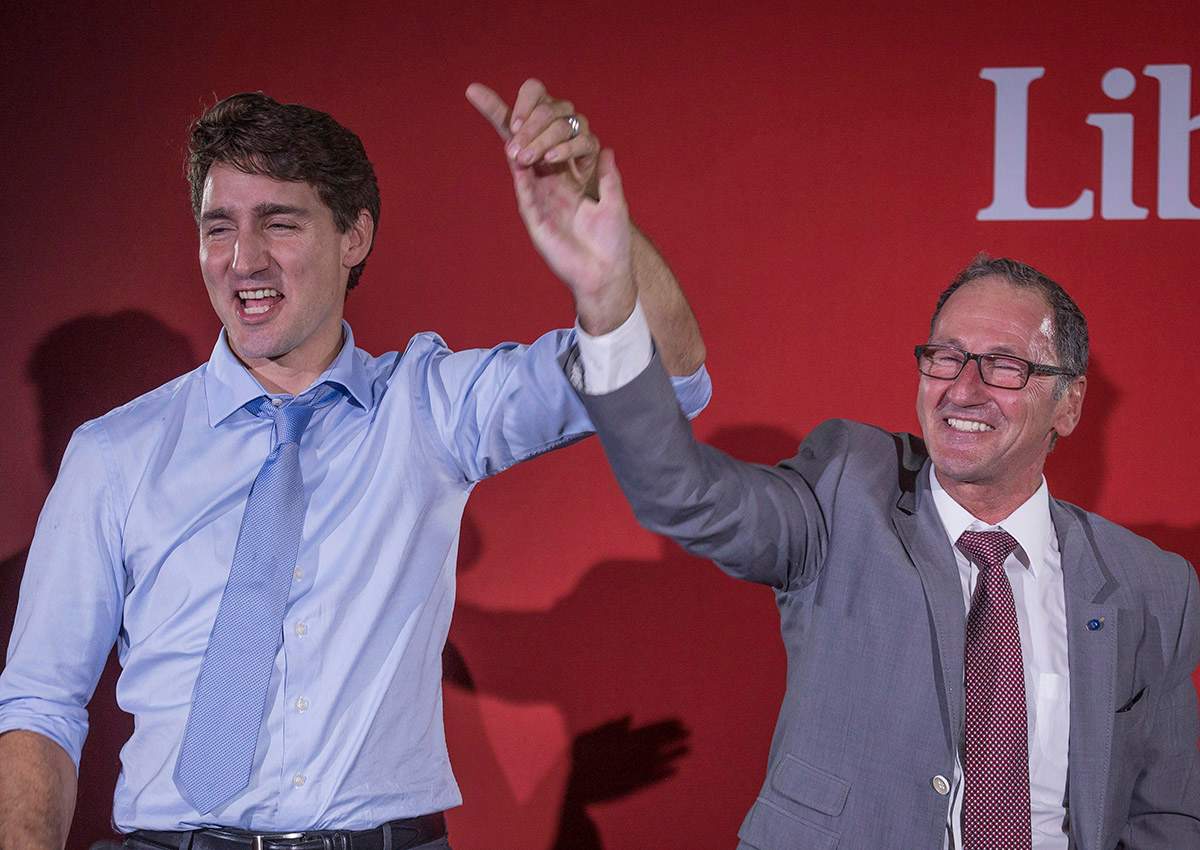 Richard Hebert, Liberal candidate for the byelection in the Lac-Saint-Jean riding, right, cheers with Prime Minister Justin Trudeau during a Liberal party rally in Dolbeau-Mistassini, Que, on Thursday, October 19, 2017. 