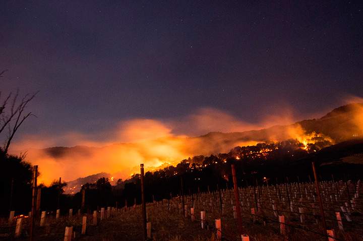 Fire glows on a hillside in Napa, California on October 9, 2017.