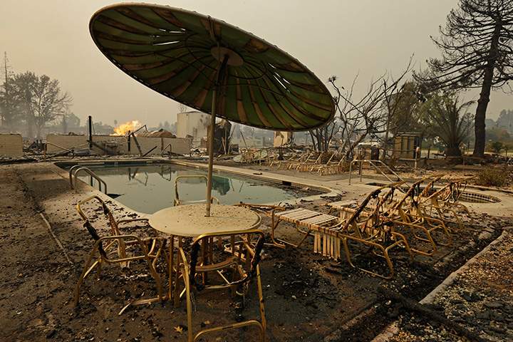 Fire burns from an open gas valve near the pool area at a trailer park on Monday, Oct. 9, 2017, in Santa Rosa, California.