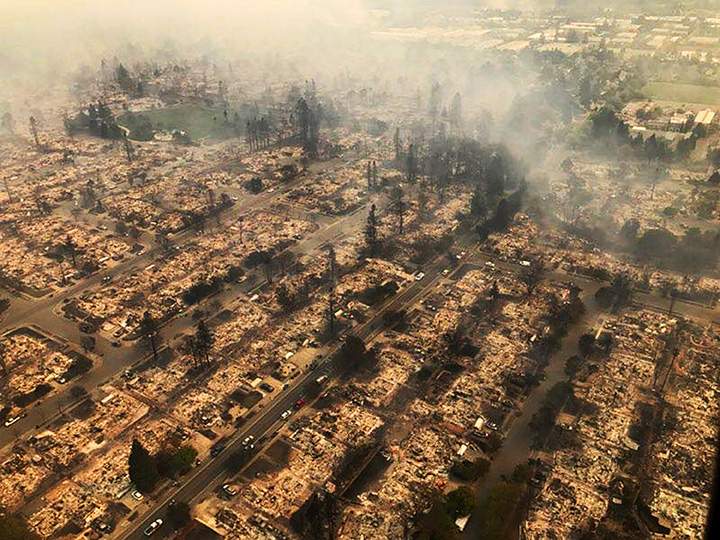 This aerial photo provided by the California Highway Patrol shows some of hundreds of homes destroyed in a wind-driven wildfire that swept through Santa Rosa, Calif., early Monday, Oct. 9, 2017.