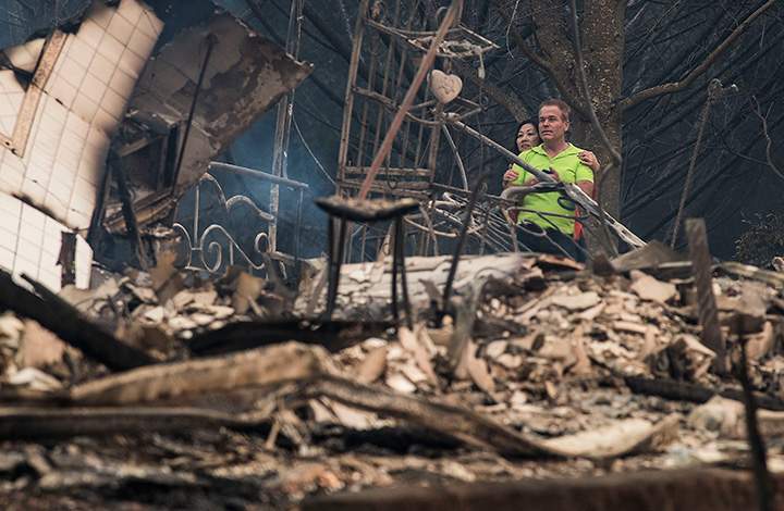 Mark Williams, right, and friend Norina Wong, look over the destruction in their neighbouhood in Santa Rosa, California on October 9, 2017.