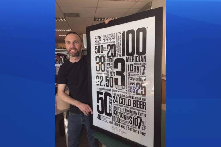 Erin McGuire poses with his graphic design, 'By the Numbers,' which he created in honour of Gord Downie and The Tragically Hip.