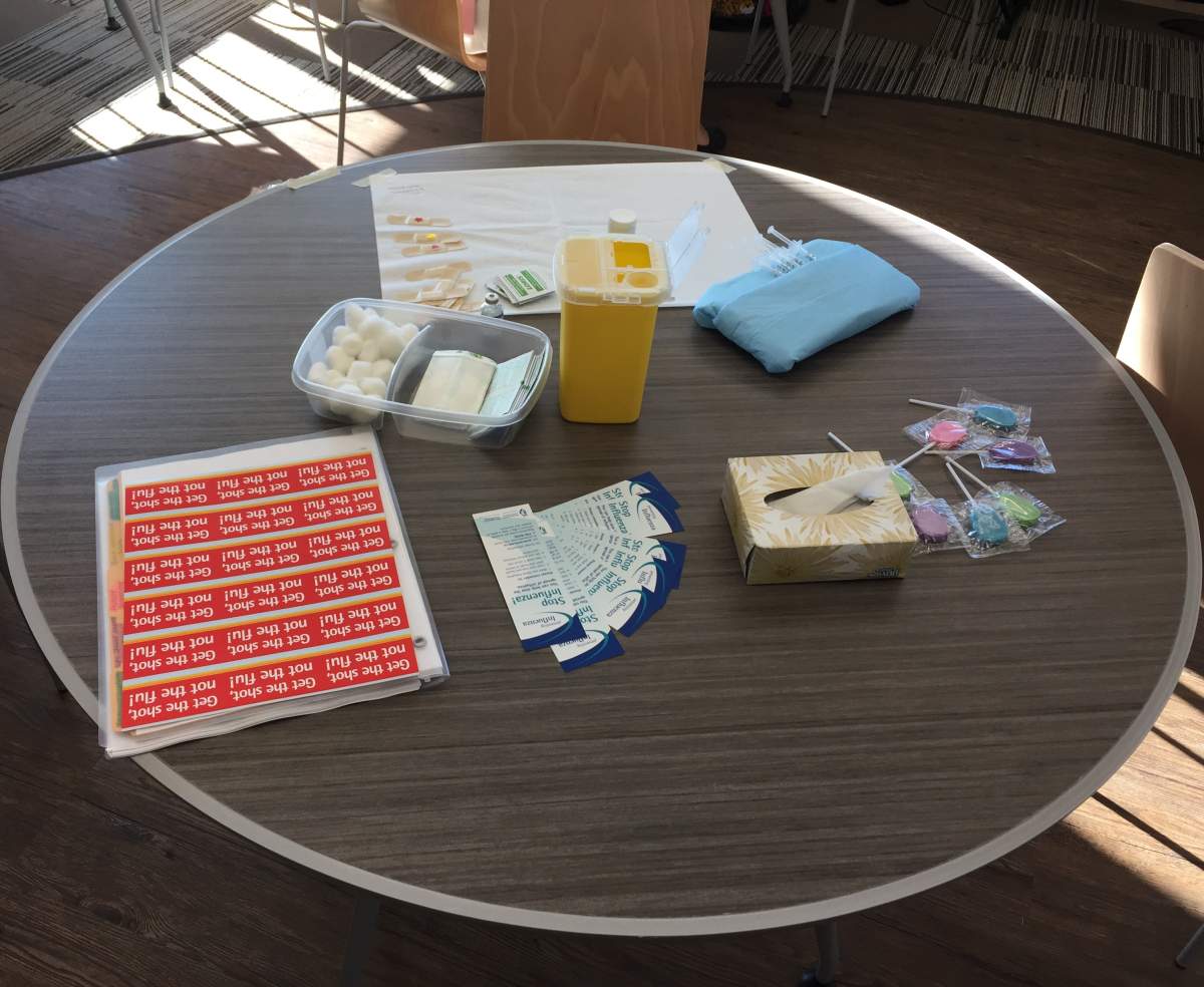A table contains everything necessary to administer the flu shot.