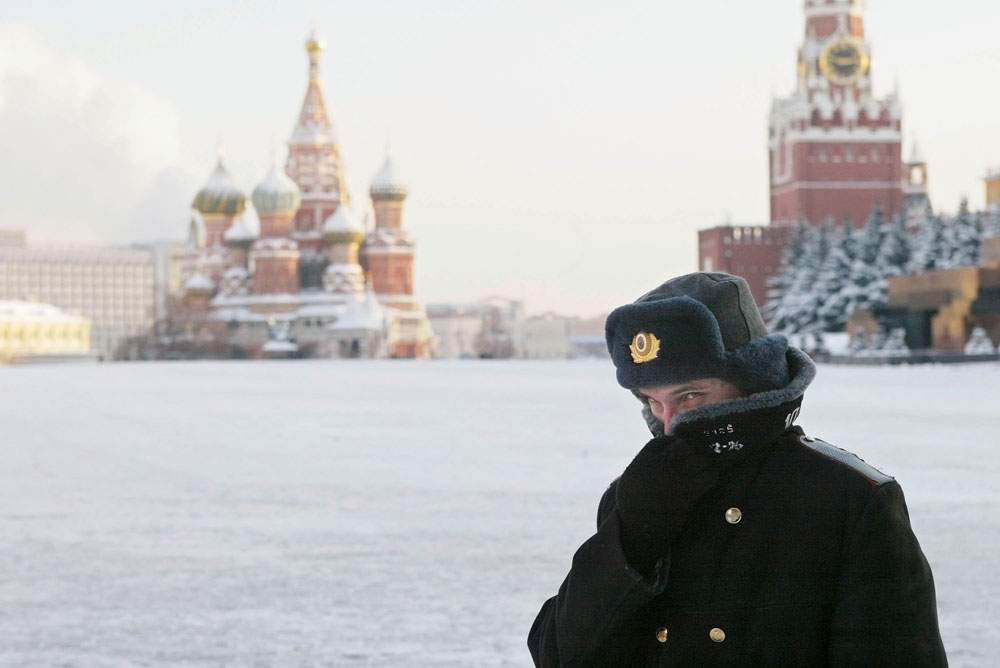 A Russian police officer, braving the bitter cold, patrols Red Square with the Kremlin in the background in this file image. 