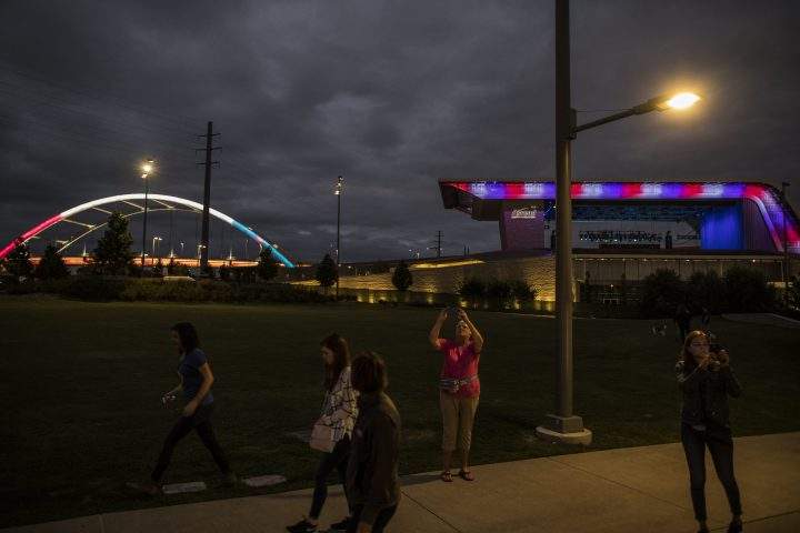 The Ascend Amphitheater and Korean Veterans Memorial Bridge in downtown Nashville, Tenn. are lit up in red, white and blue after a vigil for the victims of the mass shooting in Las Vegas.