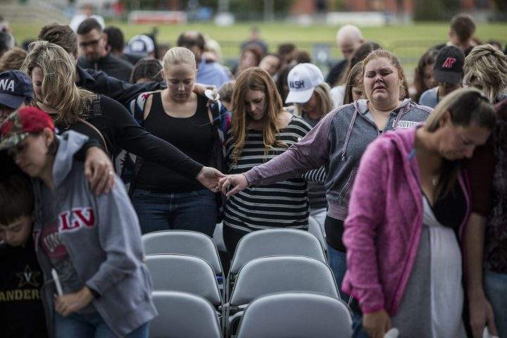 People gather at the Ascend Amphitheater for a vigil honoring the victims of the mass shooting in Las Vegas on Oct. 2, 2017 in Nashville, Tennessee.