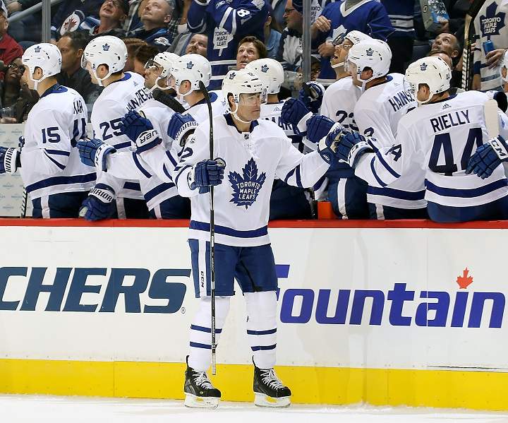 Patrick Marleau of the Toronto Maple Leafs celebrates his second period goal against the Winnipeg Jets with teammates at the bench at Bell MTS Place on Oct. 4, 2017 in Winnipeg.