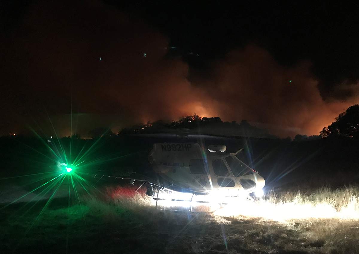 A helicopter is seen near Atlas Peak Road during an operation to rescue people trapped by wildfire in Napa, California, U.S., October 9, 2017.