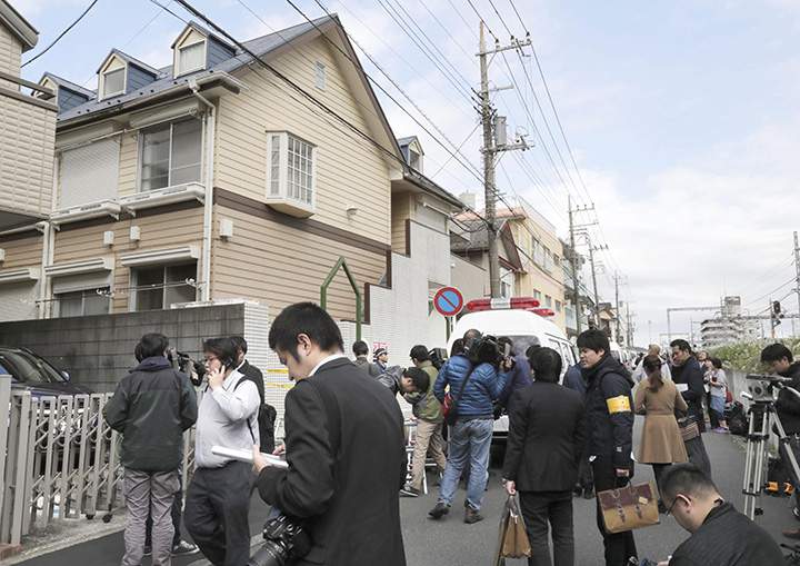 People gather in front of the apartment where police found dismembered bodies in coolers in Zama city, southwest of Tokyo, Tuesday, Oct. 31, 2017.