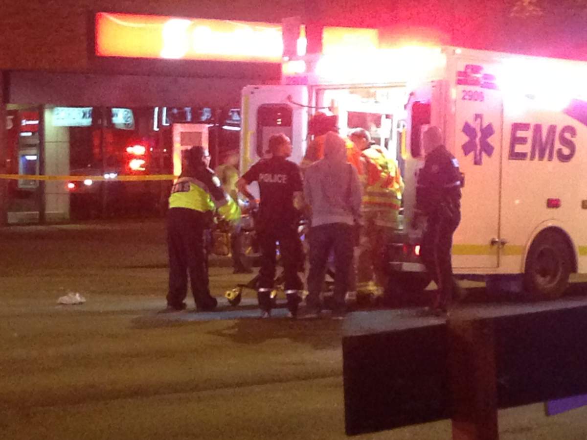 An injured person being loaded into an ambulance on Jasper Avenue near 107 Street. October 1, 2017.