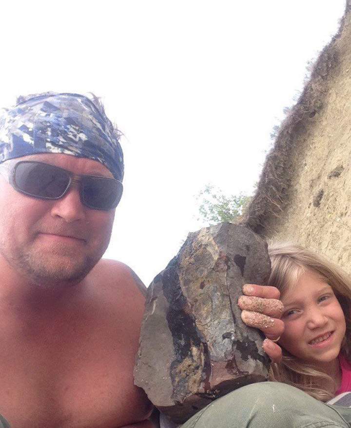 Jon Ganshorn and his daughter Lily pose with a fossil in this recent handout photo.