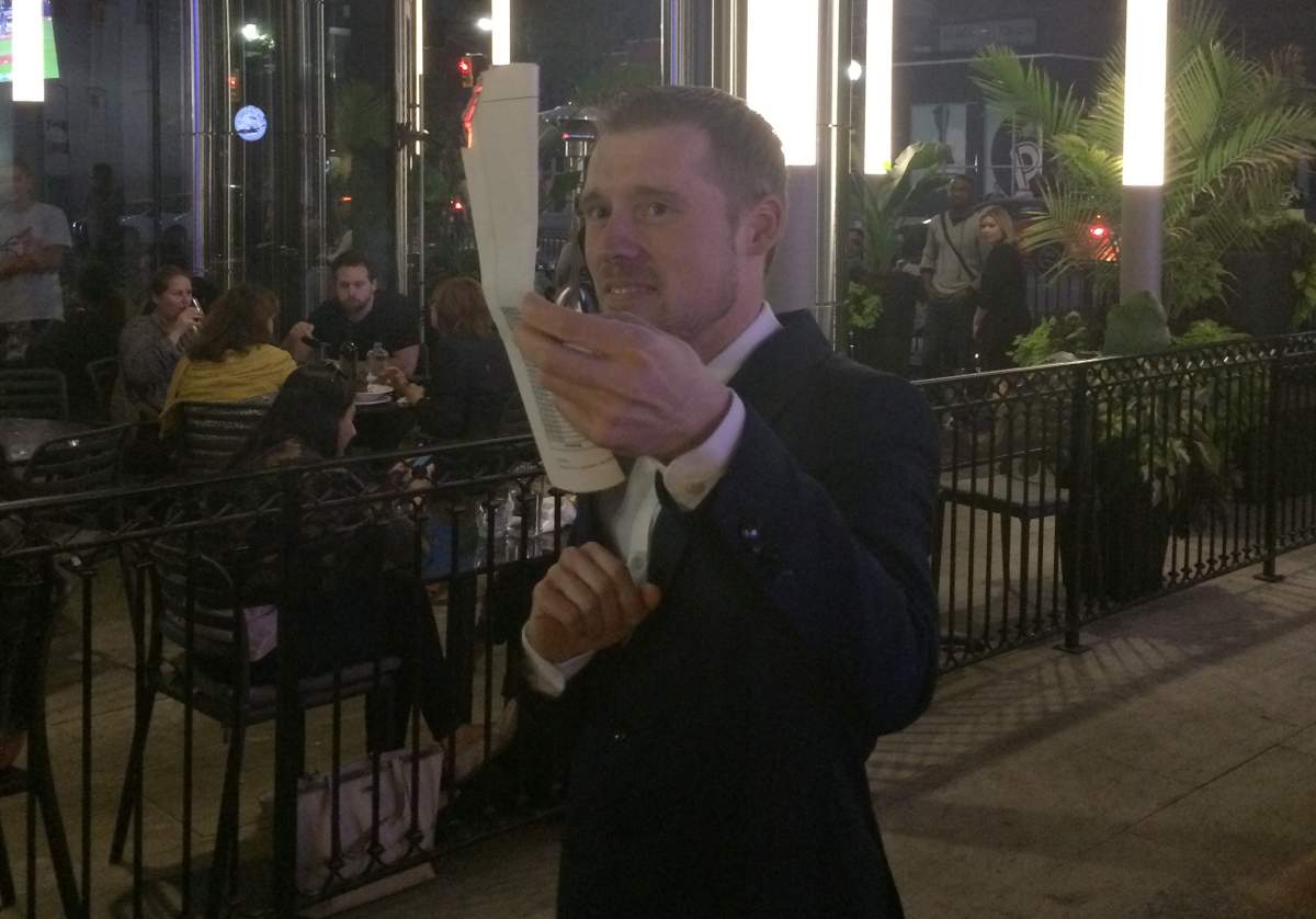 Sean Cooper burns his mortgage papers in 2015.