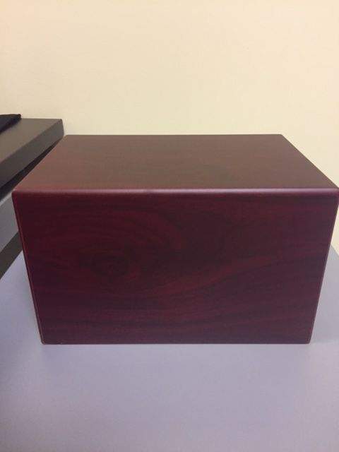 Police have recovered this red wooden urn, which was stolen during a break-in at a Didsbury, Alta.-area home on Thursday, Oct. 12, 2017.