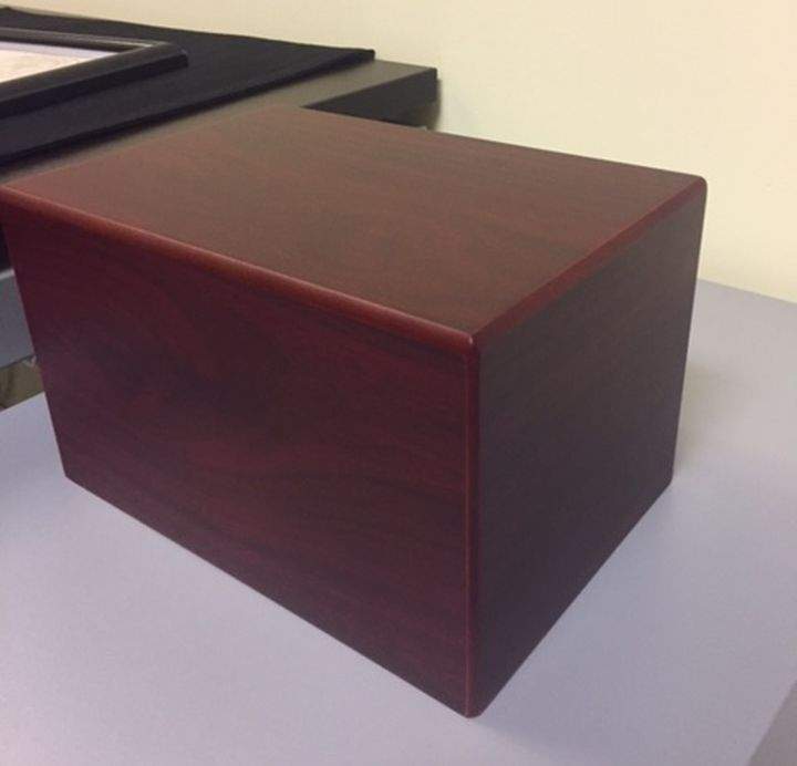 Police have recovered this red wooden urn, which was stolen during a break-in at a Didsbury, Alta.-area home on Thursday, Oct. 12, 2017.
