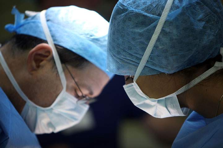 A surgeon and his theatre team at The Queen Elizabeth Hospital on March 16, 2010 in Birmingham, England. Some NHS units are restricting some surgery for obese patients and those who smoke. 