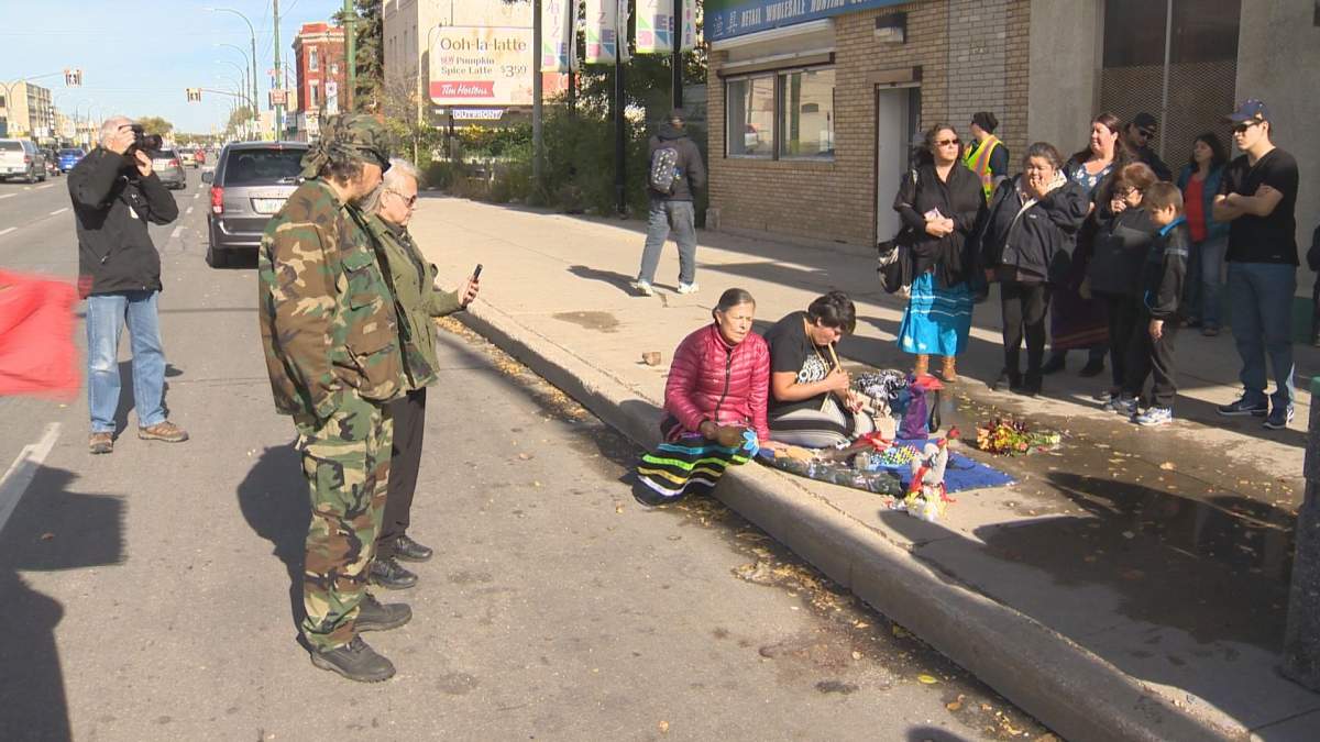 Family members hold a vigil in Winnipeg's North End Oct. 11 to honour a loved-one killed by an off-duty city cop.