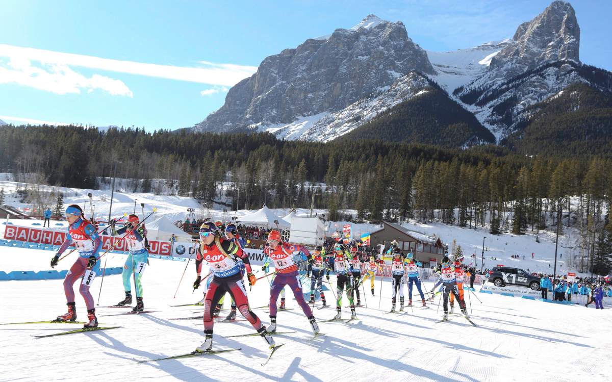 The first racers leave the start area in the team mixed relay at the IBU World Cup biathlon in Canmore, Alta., Sunday, Feb. 7, 2016.