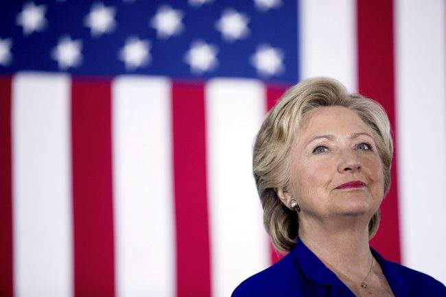 Hillary Clinton smiles on stage at a rally at the Plumbers and Pipe fitters Local 525 Union Hall in Las Vegas, Nov. 2, 2016. 