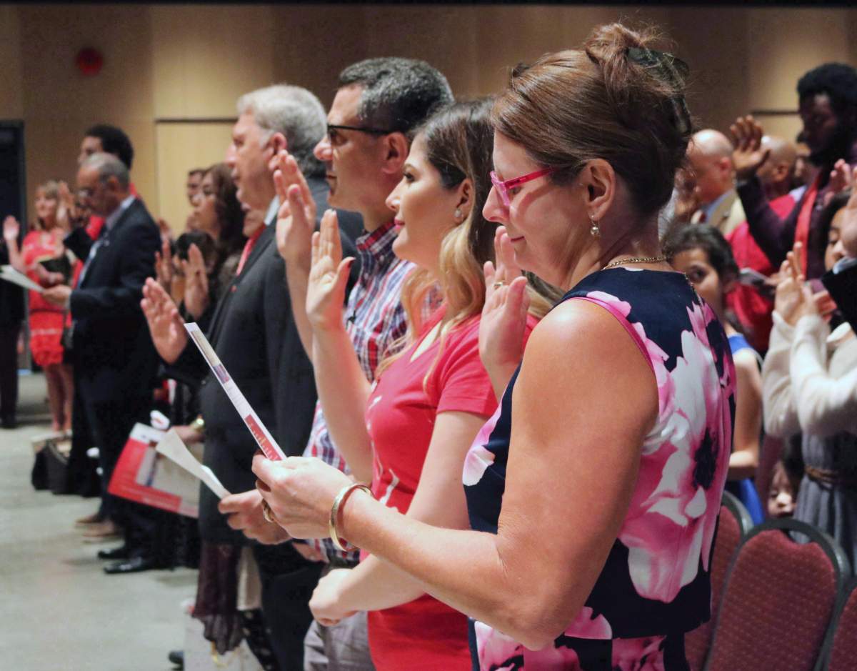 People take the citizenship oath at Pier 21 immigration centre in Halifax on July 1, 2017. 