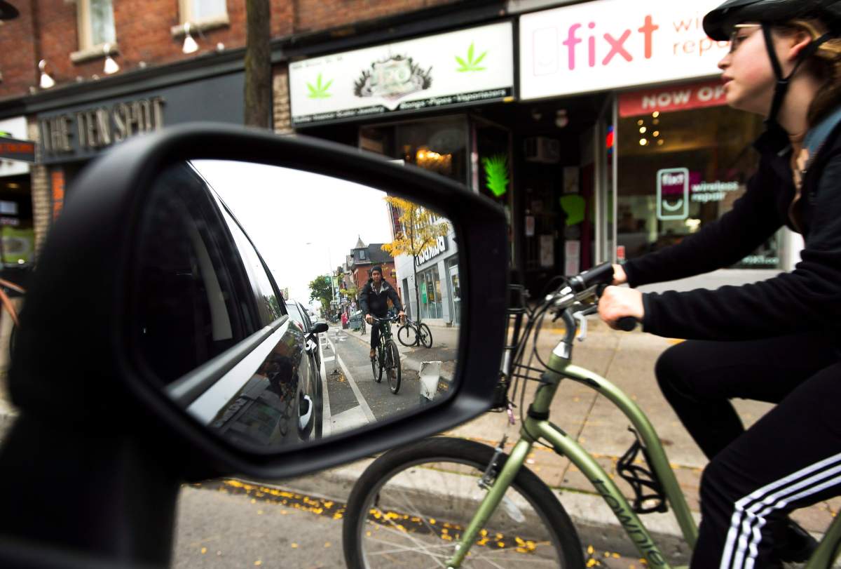 Cyclists ride on the designated Bloor Street bike lanes in Toronto on Thursday, October 12, 2017. When a stretch of separated bicycle lanes along a major thoroughfare in Toronto was recently made permanent, cyclists rejoiced and local politicians heralded the move as a major step forward for Canada's most populous city. T.