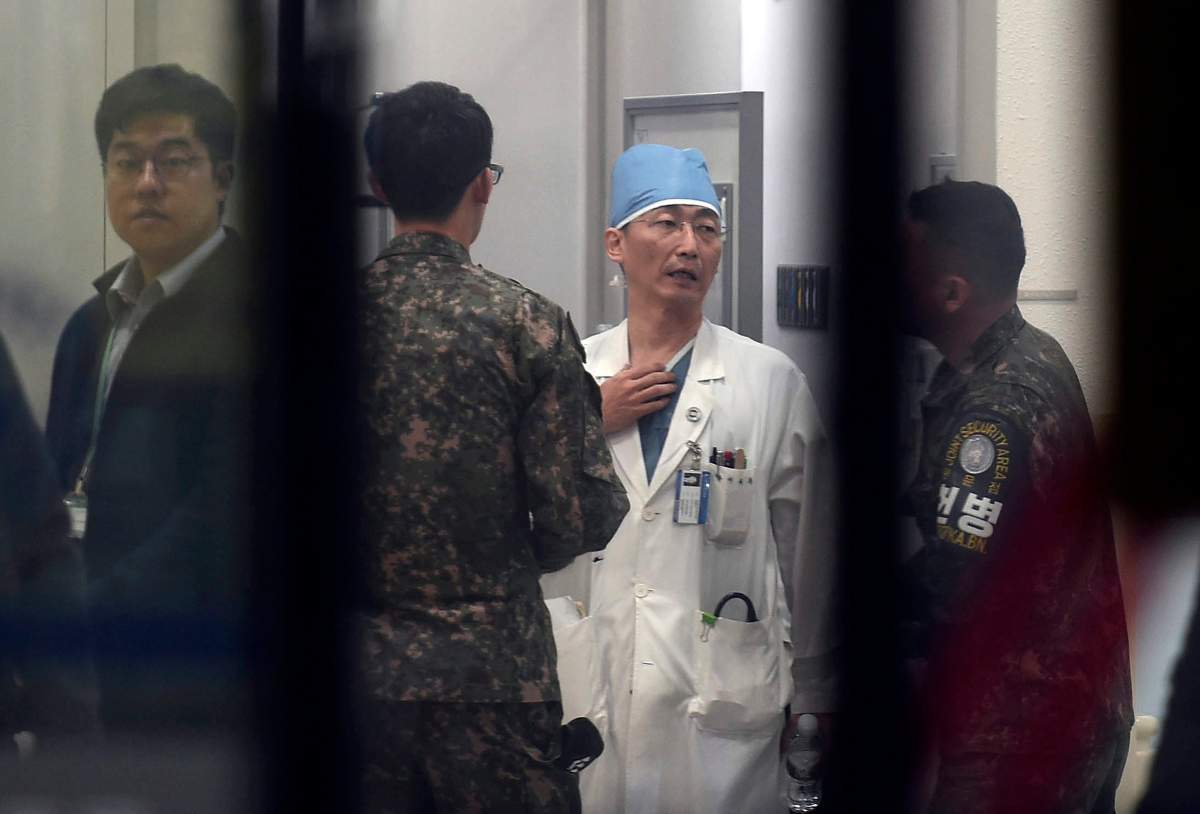 South Korean army soldiers talks with a medical doctor as he prepares to treat an unidentified injured person, unseen, believed to be a North Korean soldier, at a hospital in Suwon, South Korea, Monday, Nov. 13, 2017. North Korean soldiers shot at and wounded a fellow soldier who was crossing a jointly controlled area at the heavily guarded border to defect to South Korea on Monday, the South’s military said.