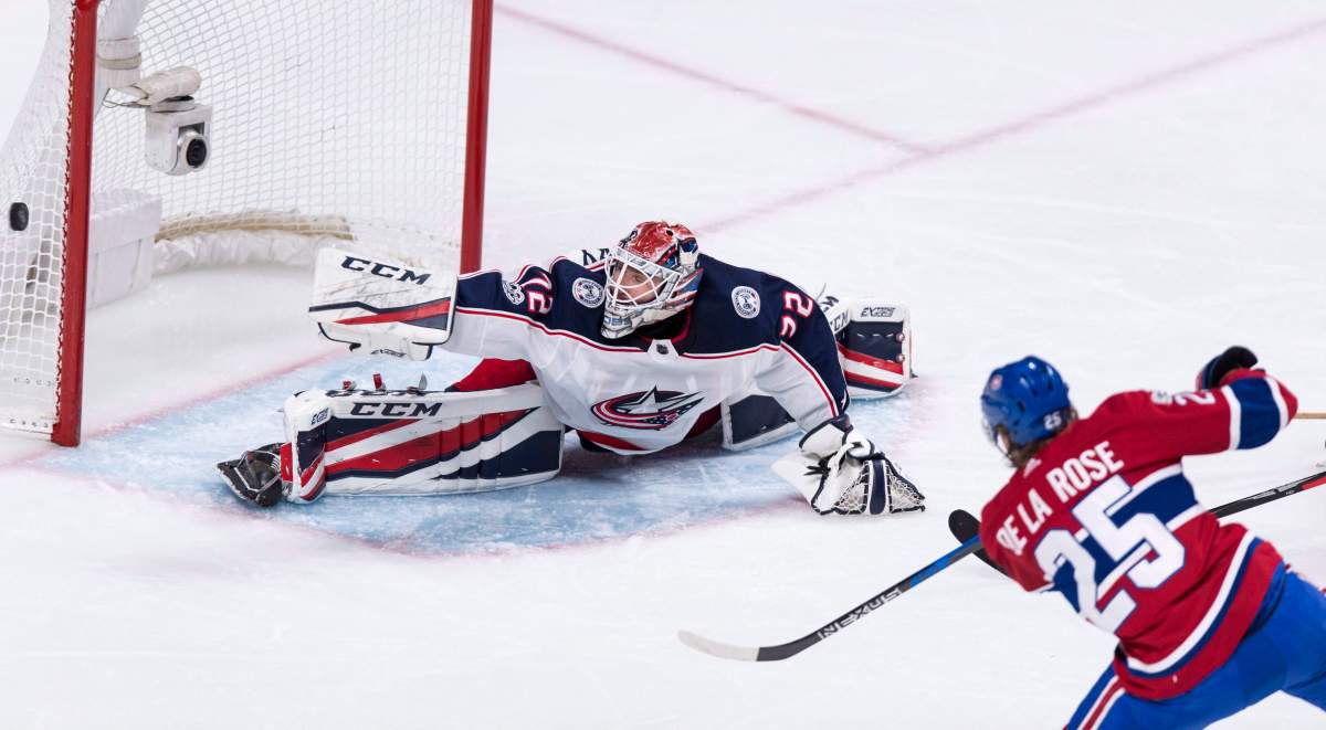 Columbus Blue Jackets goalie Sergei Bobrovsky stops a shot off the stick of Montreal Canadiens' Jacob de la Rose.