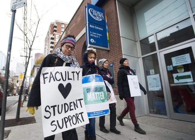 Teachers and faculty staff of the Ontario Public Service Employees Union walk the picket line at George Brown College in Toronto on Thursday, November 16, 2017. Ontario's striking college facility voted to reject a contract offer and continue their nearly five-week job action. The 12,000 college professors, instructors, counsellors, and librarians have been off the job since Oct. 15, leaving some 500,000 students out of class. THE CANADIAN PRESS/Nathan Denette.