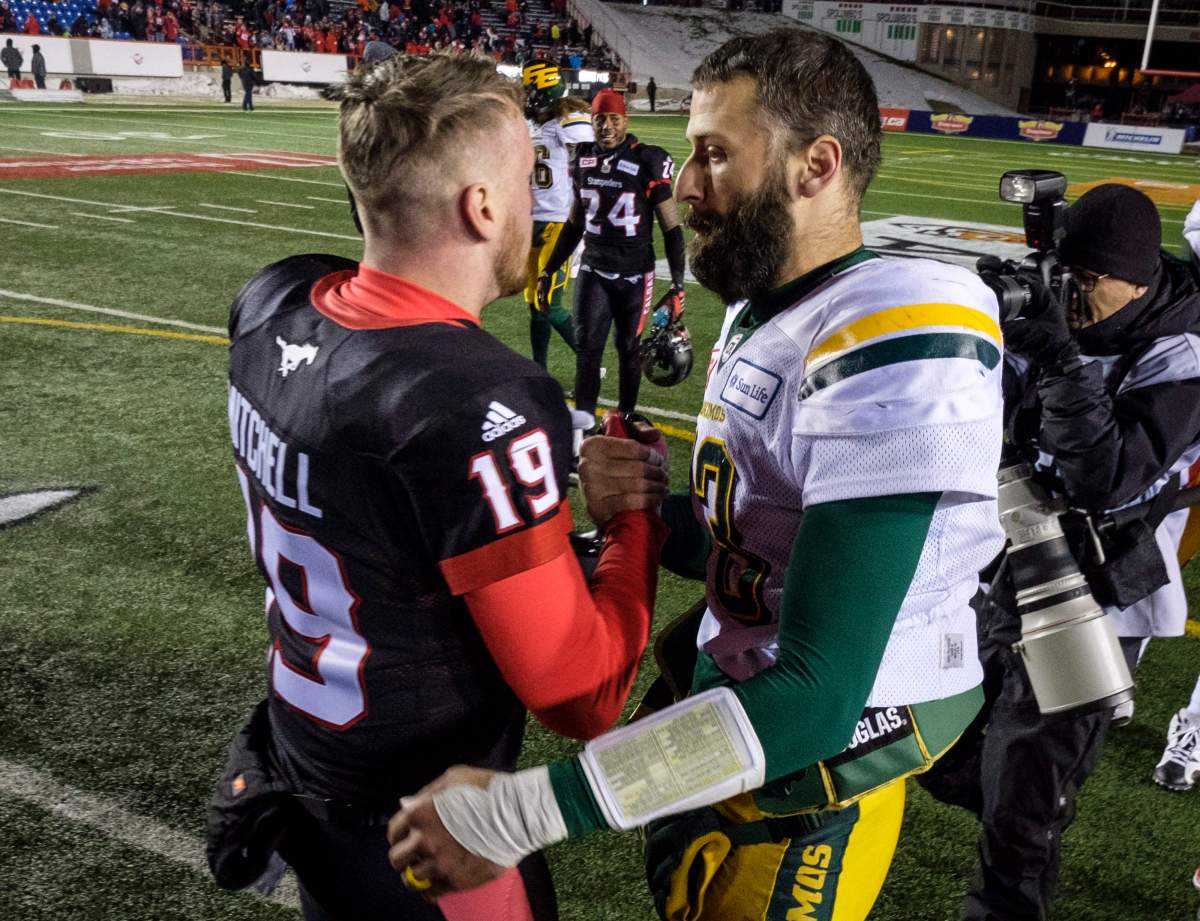 Edmonton Eskimos quarterback Mike Reilly, right, congratulates Calgary Stampeders quarterback Bo Levi Mitchell following the CFL West Final football game in Calgary, Sunday, Nov. 19, 2017.THE CANADIAN PRESS/Jeff McIntosh.
