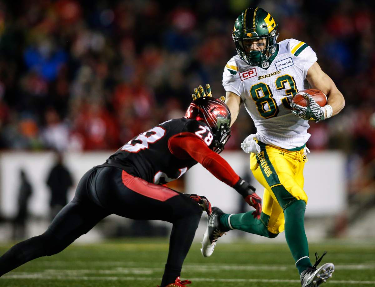 Edmonton Eskimos’ Brandon Zylstra, right, runs the ball as Calgary Stampeders’ Brandon Smith closes in during second half CFL West Final football action in Calgary, Sunday, Nov. 19, 2017.THE CANADIAN PRESS/Jeff McIntosh