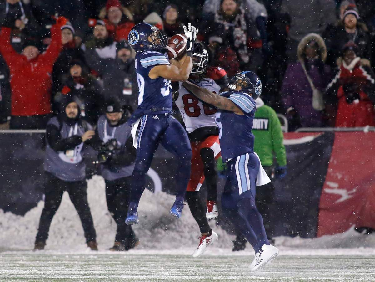 The Toronto Argonauts Matt Black (39) catches an interception intended for the Calgary Stampeders Kamar Jorden (88) while the Toronto Argonauts Jermaine Gabriel (5) looks on during fourth quarter CFL Grey Cup action in Ottawa on Sunday, November 26, 2017.  