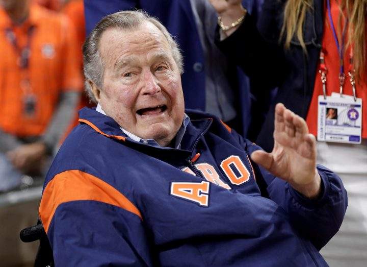 Former U.S. President George H.W. Bush waves from the field before Game 5 of the 2017 World Series between the Los Angeles Dodgers and the Houston Astros in Houston, Texas, on Oct. 29, 2017.    