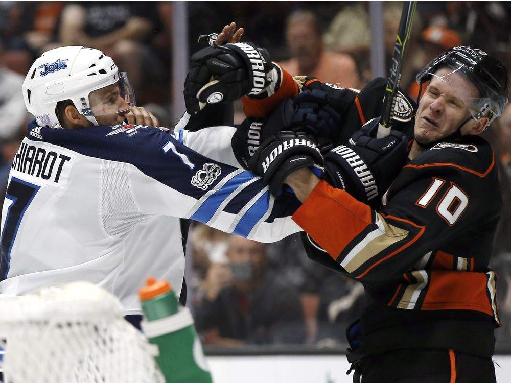 Winnipeg Jets defenseman Ben Chiarot tangles with Anaheim Ducks right wing Corey Perry during the second period of an NHL hockey game in Anaheim, Calif., Friday, Nov. 24, 2017. (AP Photo/Alex Gallardo) ORG XMIT: ANA106.