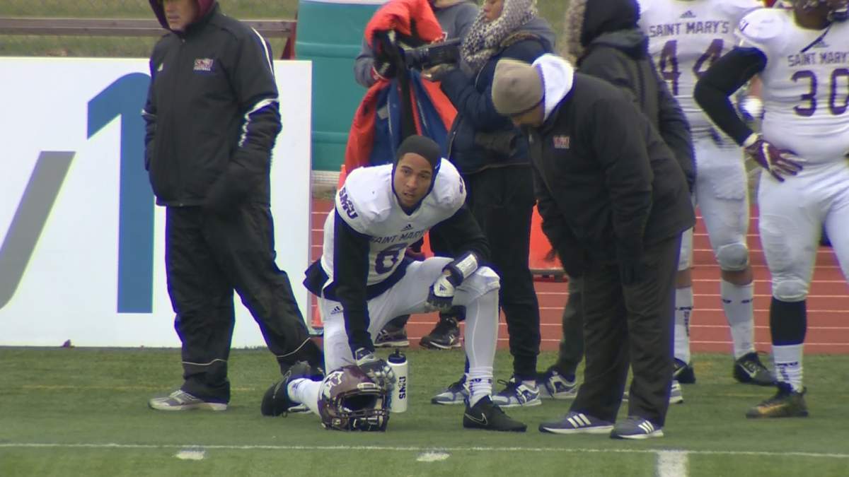 Archelaus Jack kneels on the sidelines of Tuesday's Loney Bowl game. 