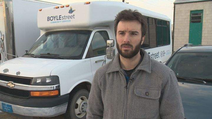 Aidan Inglis, director of programs at Boyle Street Community Services, stands in front of the organization's warming bus on Nov. 28, 2017.