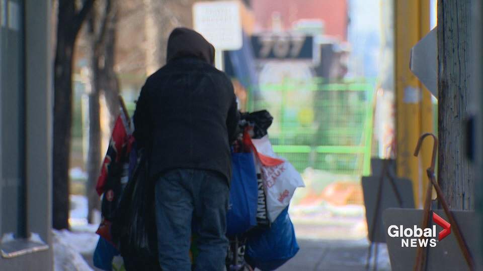 A person is seen pushing a cart in Calgary.