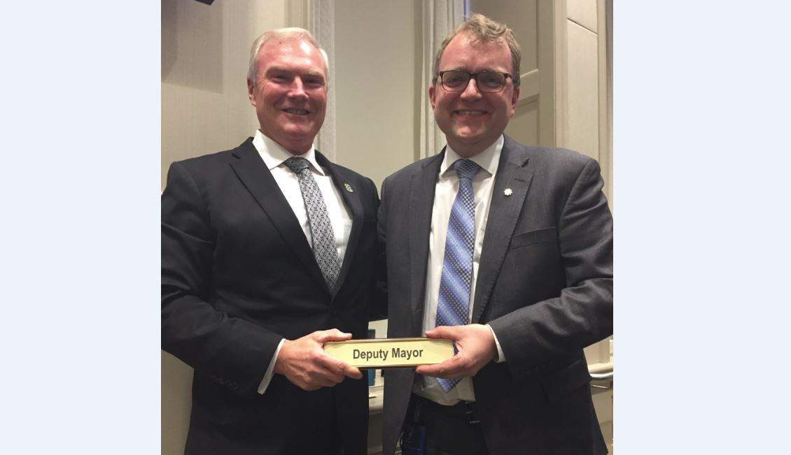 Steve Craig hands over the deputy mayor duties to Waye Mason at Tuesday's Halifax Regional Council meeting. Fellow councillor Tony Mancini snapped this photo.  