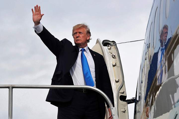 U.S. President Donald Trump boards Air Force One on November 14, 2017.  