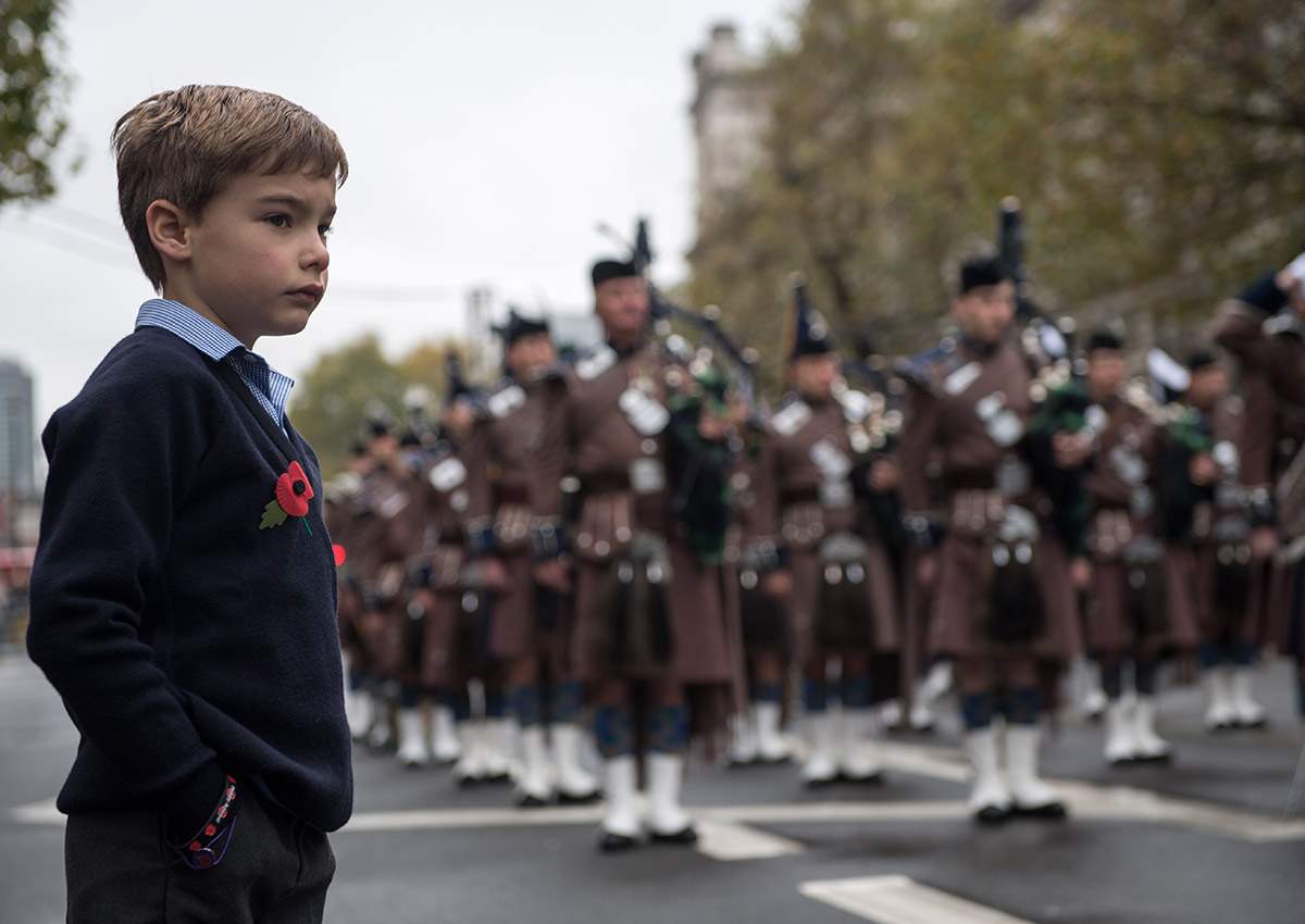 Seven year-old Mylo Jones (L) watches the ceremonies during the Western Front Association’s (WFA) annual service of remembrance on Armistice Day, at the Cenotaph in central London on November 11, 2017.