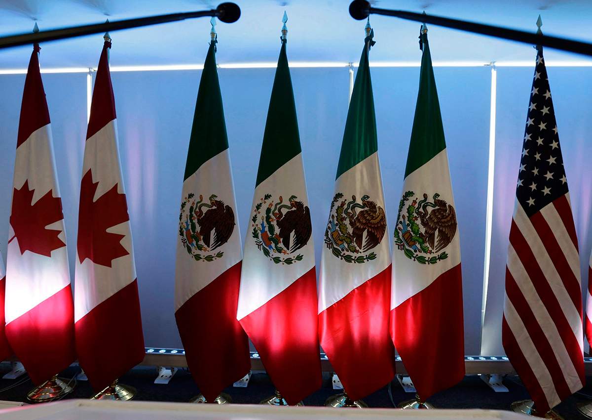 National flags representing Canada, Mexico, and the U.S. are lit by stage lights at the North American Free Trade Agreement, NAFTA, renegotiations, in Mexico City, on September 5, 2017. 