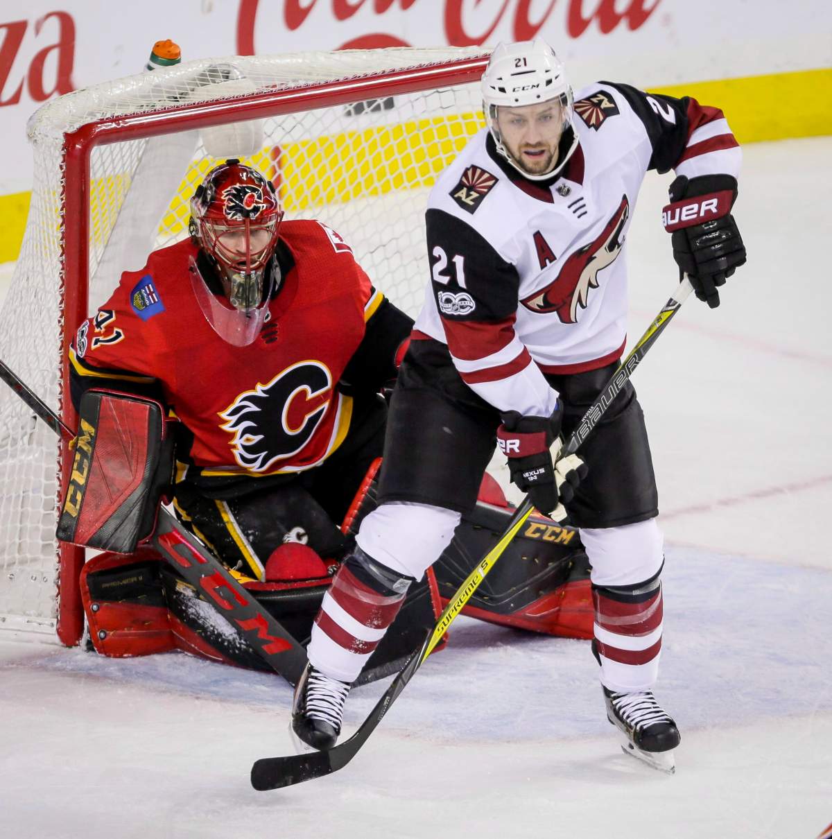 Arizona Coyotes' Derek Stepan screens Calgary Flames goalie Mike Smith during second period NHL hockey action in Calgary, Thursday, Nov. 30, 2017.THE CANADIAN PRESS/Lyle Aspinall.
