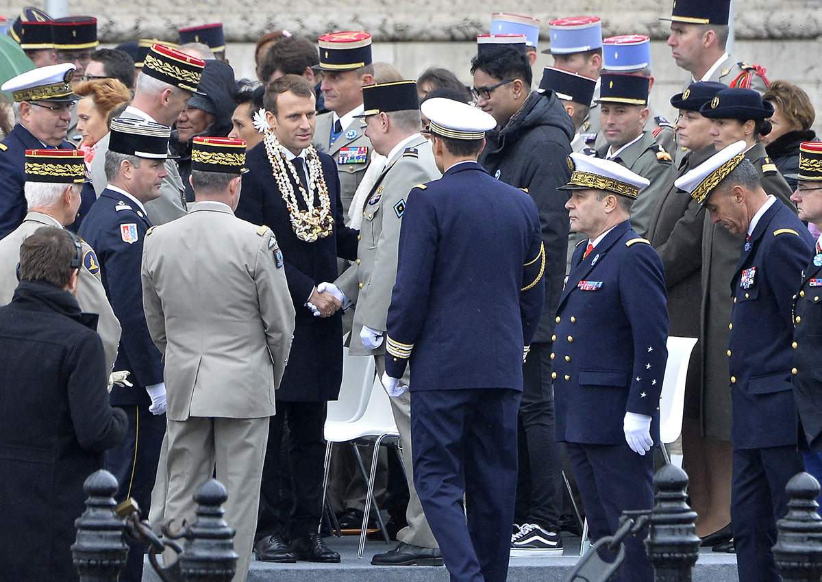 Emmanuel Macron greets officers and receives a garland during the Commemoration of Armistice Day ceremony on November 11, 2017 in Paris, France. The ceremony marks the 99th anniversary of the end of World War I.