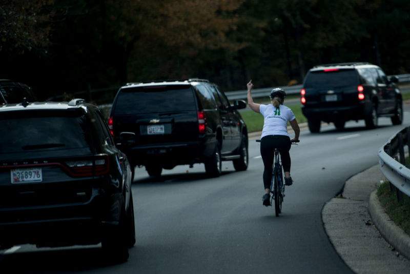 Juli Briskman was on her bicycle last month when Trump's motorcade drove by. A photo that quickly went viral shows her raising the middle finger of her left hand in defiance.