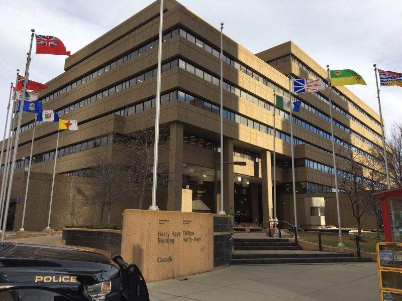 Calgary police evacuate the Harry Hays Building on 4 Avenue S.E. on Thursday, Nov. 30, 2017.