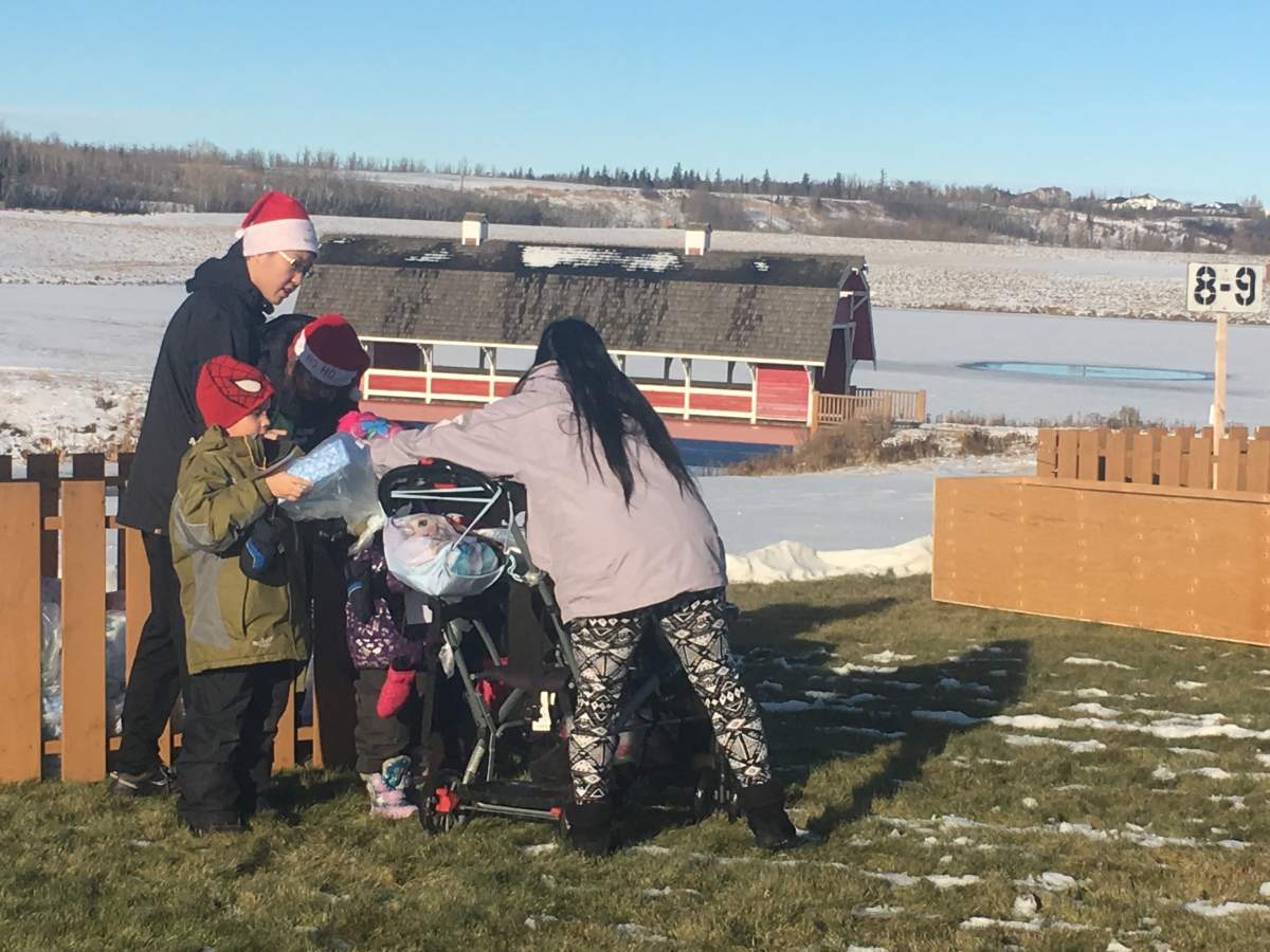 This family is just picking up their Christmas presents. All donated and sorted by age.