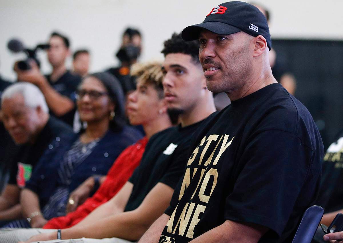In this June 23, 2017, file photo, LaVar Ball, right, father of Los Angeles Lakers draft pick Lonzo Ball, listens to his son during the NBA basketball team's news conference in El Segundo, Calif.